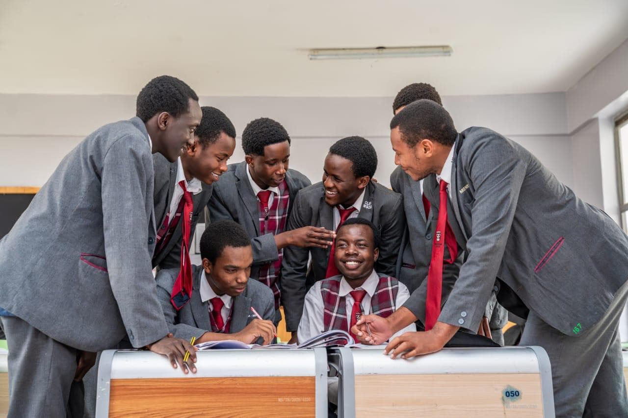 Merishaw School students collaborating around a classroom desk