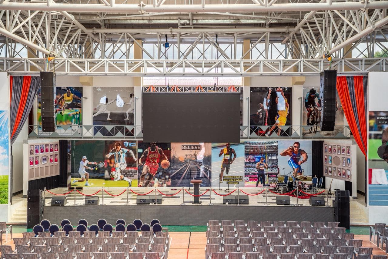 Merishaw School multipurpose hall with stage, large screen, and seating