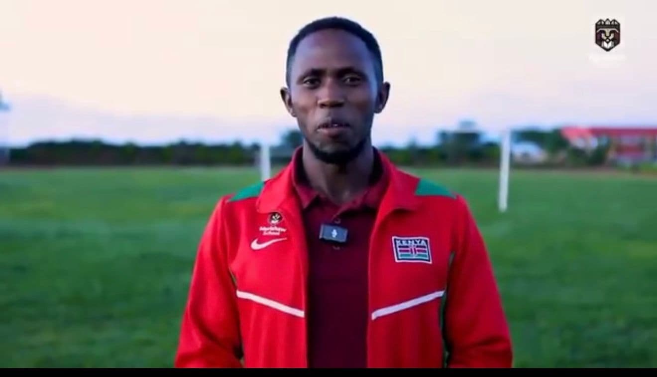 Merishaw School sports coach speaking beside the school field