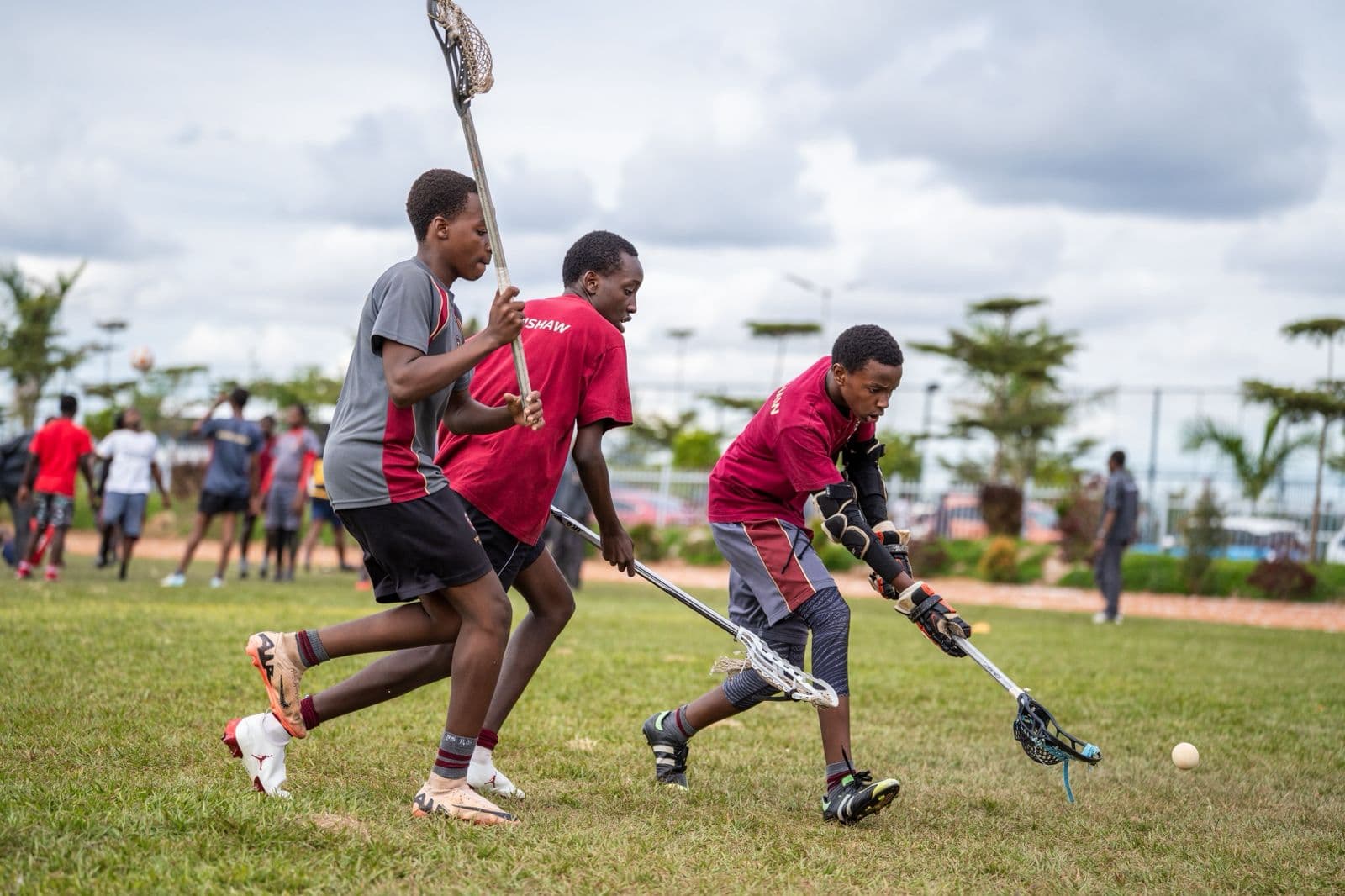 Merishaw School students playing lacrosse on the field